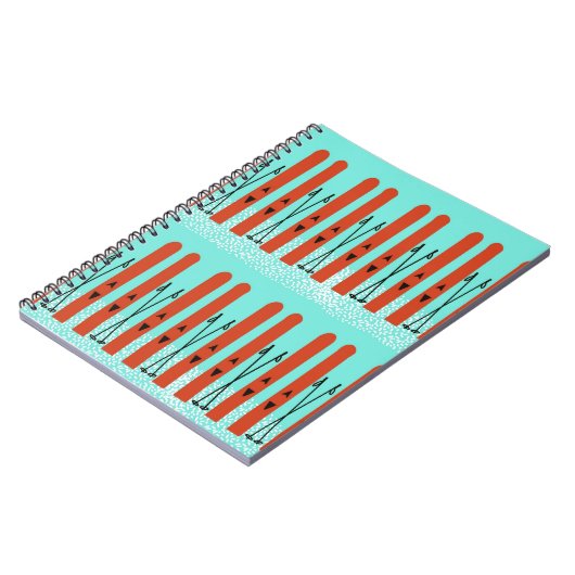 Rote Skier auf blauem Notebook Notizblock (Linke Seite)