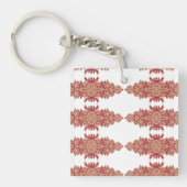 Rote und orangefarbene Blütengestaltung mit Ziergr Schlüsselanhänger (Vorderseite)