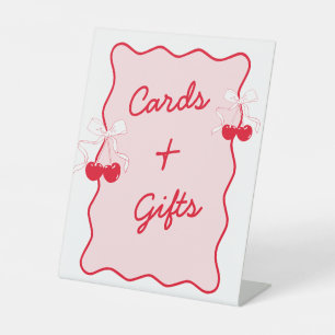 Rote und rosa Kirschenkarte und Geschenke Sockelschild