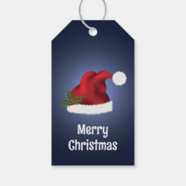 Rote Weihnachtsmannmütze mit Weihnachts-Holly auf Geschenkanhänger