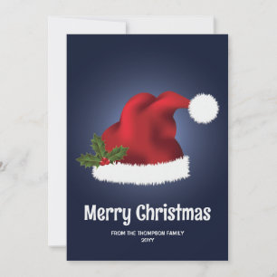 Rote Weihnachtsmannmütze mit Weihnachtsstechpalme Feiertagskarte