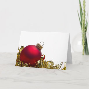 Roter Weihnachtsflitter und Goldlametta auf Weiß Feiertagskarte