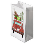Rotes Auto mit Weihnachtsgeschenken Kleine Geschen Geschenktüte (Vorderseite Schrägansicht)