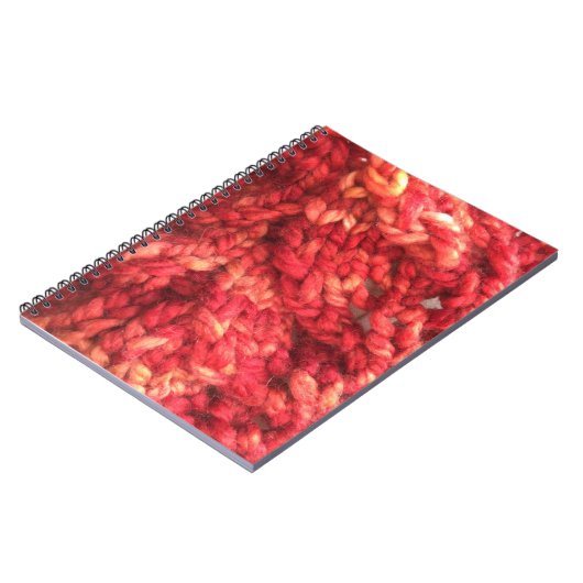 Rotes strickendes Notizbuch Notizblock (Linke Seite)