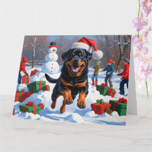 Rottweiler läuft im Schnee mit Weihnachtshut Karte