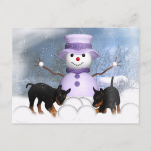 Rottweiler-Welpen, die im Schnee spielen Postkarte