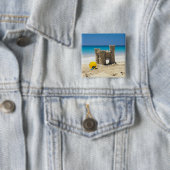 Sand-Schloss und Eimer auf tropischem Strand Button (Beispiel)