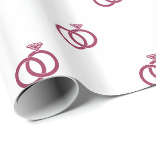 Sangria-Rosa Hochzeitsringe auf Weiß Geschenkpapier
