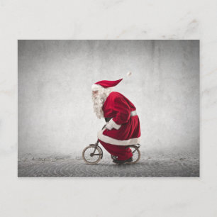 Santa Claus fährt Fahrrad Feiertagspostkarte