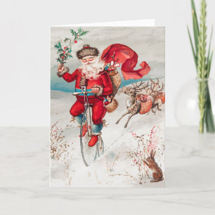 Santa Claus Reitrad, Rentier und Kaninchen Feiertagskarte