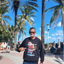 Santa Claus relaxes before the Christmas on a Grey Sweatshirt