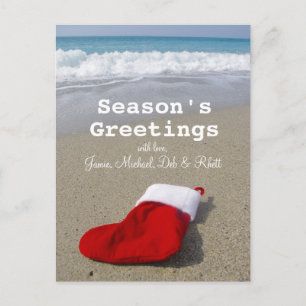 Santa Claus sock laying on beautiful beach Feiertagspostkarte