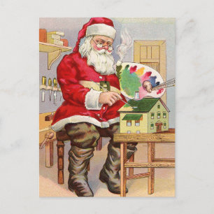 Santa malt neue Spielzeug-Häuser an Postkarte