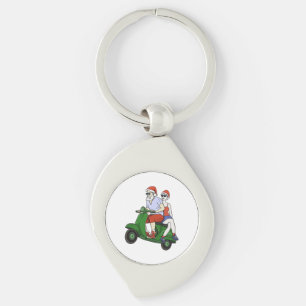 Santa und Frau Claus fahren mit einem Roller Schlüsselanhänger