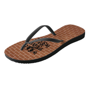 Schlappen mit individuellem Text vor einer Backste Badesandalen