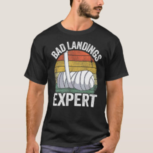 Schlechte Landungen Experte gebrochene Handkinder T-Shirt