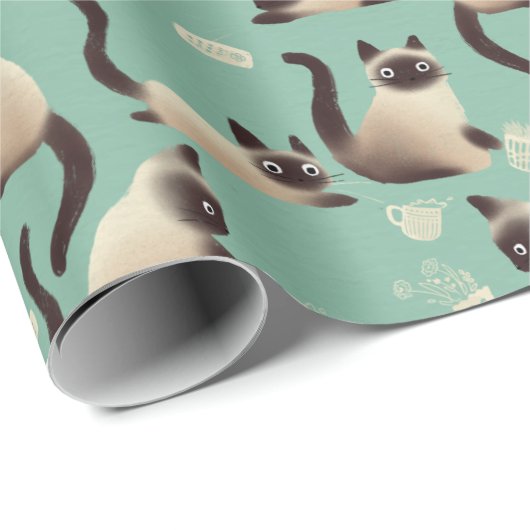 Schlechte siamesische Katzen klopfen über Geschenkpapier (Rolleneckpunkt)