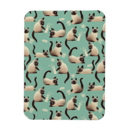 Schlechte siamesische Katzen klopfen über Magnet