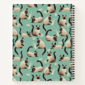 Schlechte siamesische Katzen klopfen über Notizblock (Rückseite)