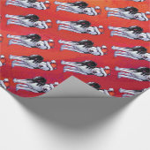 Schlittenhund in der Weihnachtsmannmütze auf Rot Geschenkpapier (Ecke)