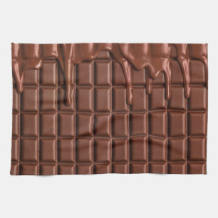 Schmelzschokolade, die über einen Schokoladenblock Geschirrtuch