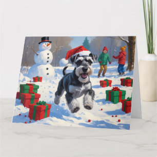 Schnauzer läuft im Schnee mit Weihnachtsmütze Karte