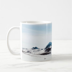 SCHNEEBEDECKTES LAND WÄHREND DER TAGESZEIT KAFFEETASSE