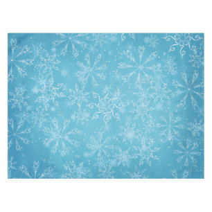 Schneeflocken auf blauer Tischdecke