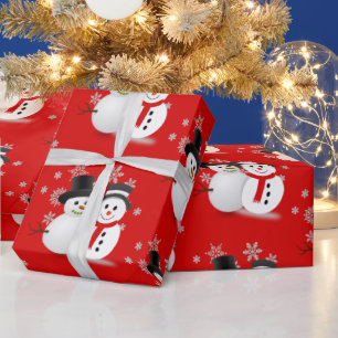 Schneemann auf rotem Weihnachts-Handwerk oder  Geschenkpapier
