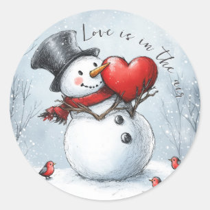 Schneemann bietet Liebe mit einem großen Herzen Runder Aufkleber