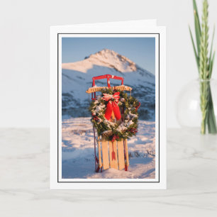 Schneeschlitten mit Weihnachtskranz Feiertagskarte