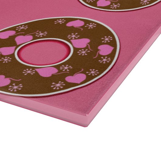 Schokoladendonuts Donuts Donuts auf rosa Schneideb Schneidebrett (Ecke)