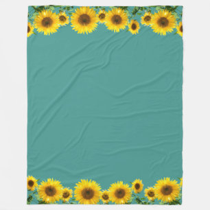 Schöne gelbe Sonnenblumen auf teal-farbenem Fleece