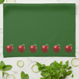 Schöne rote Äpfel auf grünem Küchenhandtuch Geschirrtuch