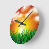 Schöner Sonnenaufgang über einem Grasfeld Runde Wanduhr (Winkel)