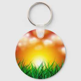 Schöner Sonnenaufgang über einem Grasfeld Schlüsselanhänger