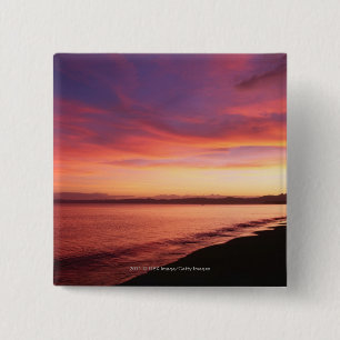 Schöner Sonnenuntergang am Strand Button