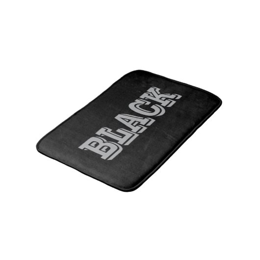 Schwarz mit grauem Text auf schwarzer, solider Far Badematte (Schrägansicht)