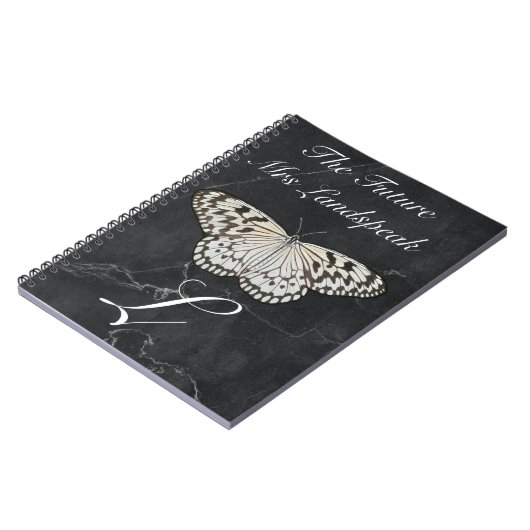 Schwarz-Weiß-Schmetterling auf schwarzem Marmorste Notizblock (Linke Seite)