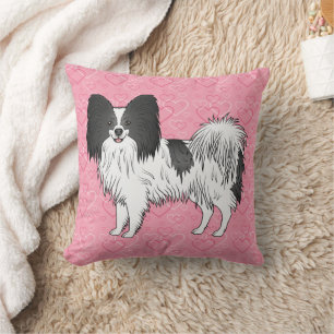 Schwarz-weißer Papillon-Hund auf rosa Herzen Kissen