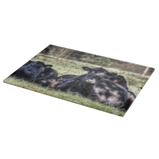 Schwarze Angus-Kühe im Weiden-Schneidebrett Schneidebrett (Ecke)