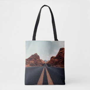 SCHWARZE ASPHALT-STRASSE ZWISCHEN BROWN ROCK FORMA TASCHE