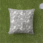 Schwarze Blätter auf weißem Kissen (Golfball-Marker)