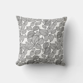 Schwarze Blätter auf weißem Kissen