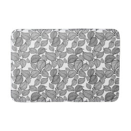 Schwarze Blätter auf weißer Bath-matte Badematte