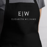 Schwarze Elegante Moderne Minimalistische Monogram Schürze<br><div class="desc">Erleben Sie kulinarische Erlebnisse mit unserer klassischen Elegant Moderne Minimalistische Monogram Name Cooking Schürze. Diese Küche ist unverzichtbar und vereint zeitlose Eleganz mit zeitgemäßem Minimalismus. Diese Schürze ist nicht nur ein praktisches Accessoire, sondern auch eine persönliche Note. Mit der individuell anpassbaren Monogramm- und Namensoption können Sie Ihre Persönlichkeit in Ihre...</div>