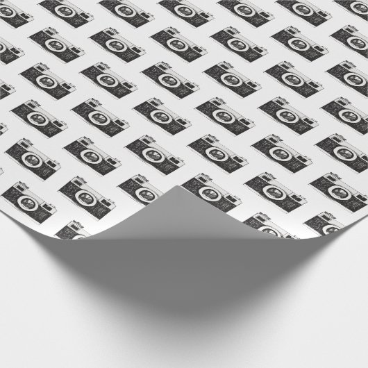 Schwarze Kamera, grau Geschenkpapier (Ecke)