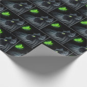 Schwarze Katze, die an einem glühenden grünen Schm Geschenkpapier (Ecke)