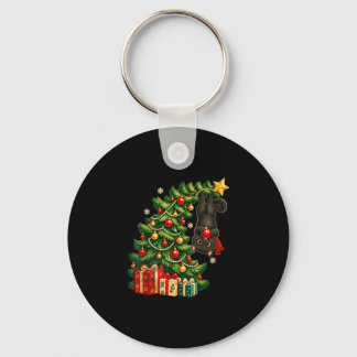 Schwarze Katze hängt am Weihnachtsbaum festliches Schlüsselanhänger