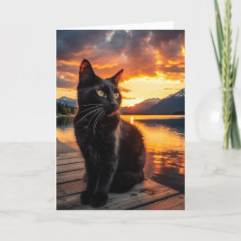 Schwarze Katze in einer wunderschönen Sonnenunterg Feiertagskarte